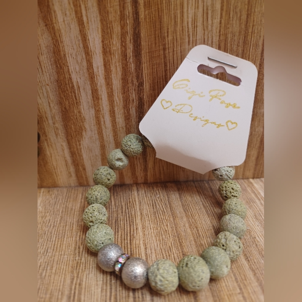 Lava rock green bracelet with silver and gem detail.